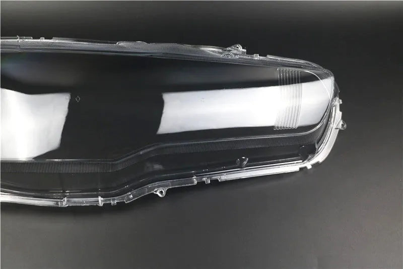 Transparent plastic automotive headlight housing cover showing clear construction