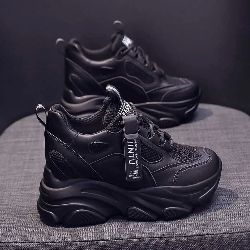 Women's black casual platform shoes with mesh upper, toe holder detail, and hollow-out design on a white background.