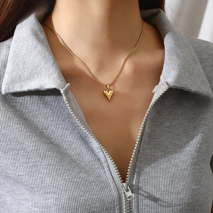Heart-shaped stainless steel necklace with snake bone chain and matching earrings in gold or steel tone