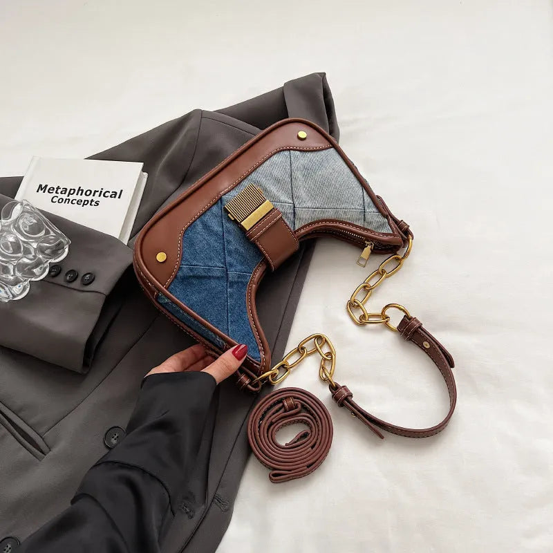 Brown denim women's bucket shoulder bag with diamond mesh detail, chain accents, and double adjustable straps
