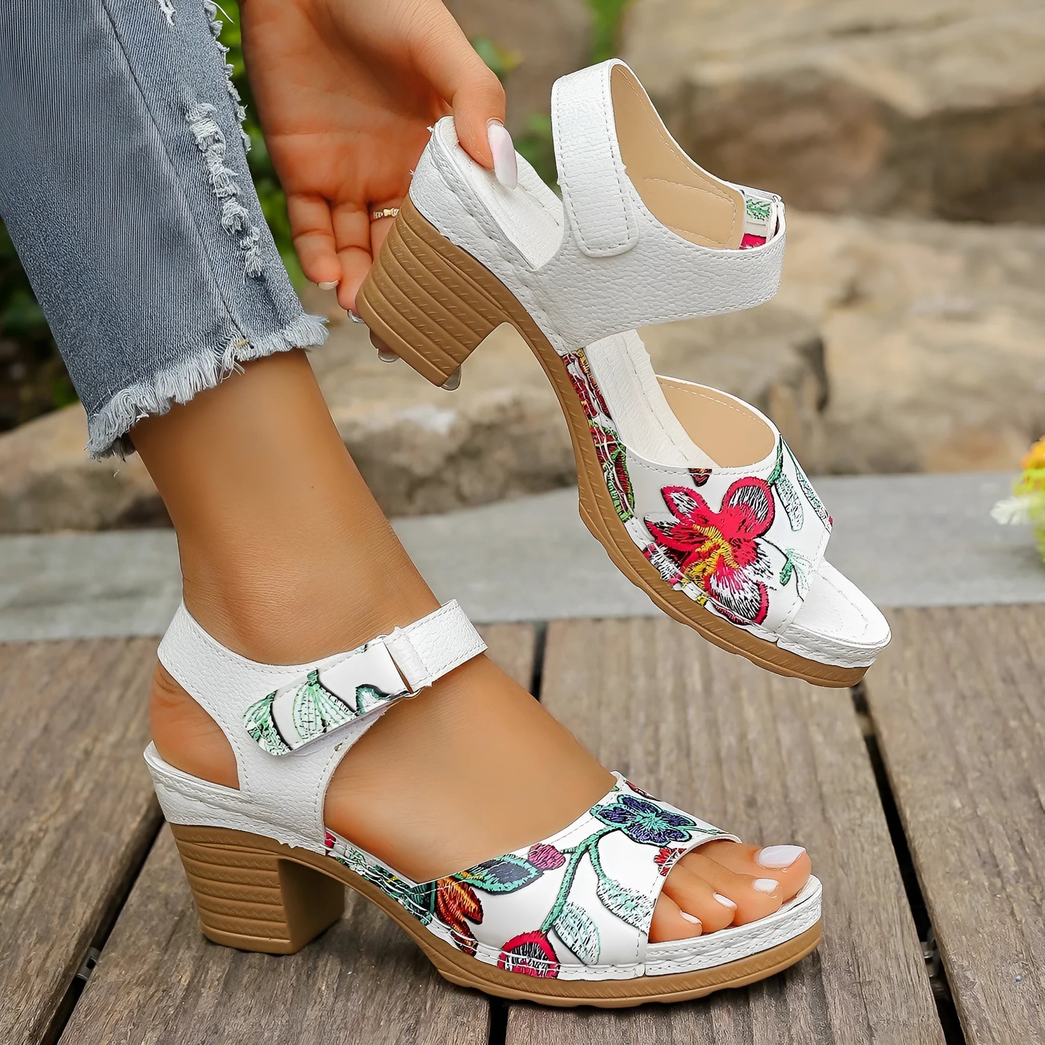 White women's high heel sandals showing velcro buckle fastening and rubber sole