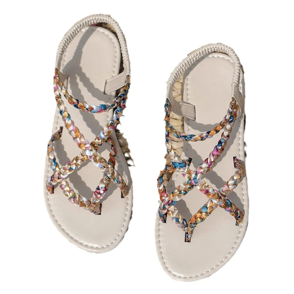 White and black flat sandals with elastic band closure and cloth upper
