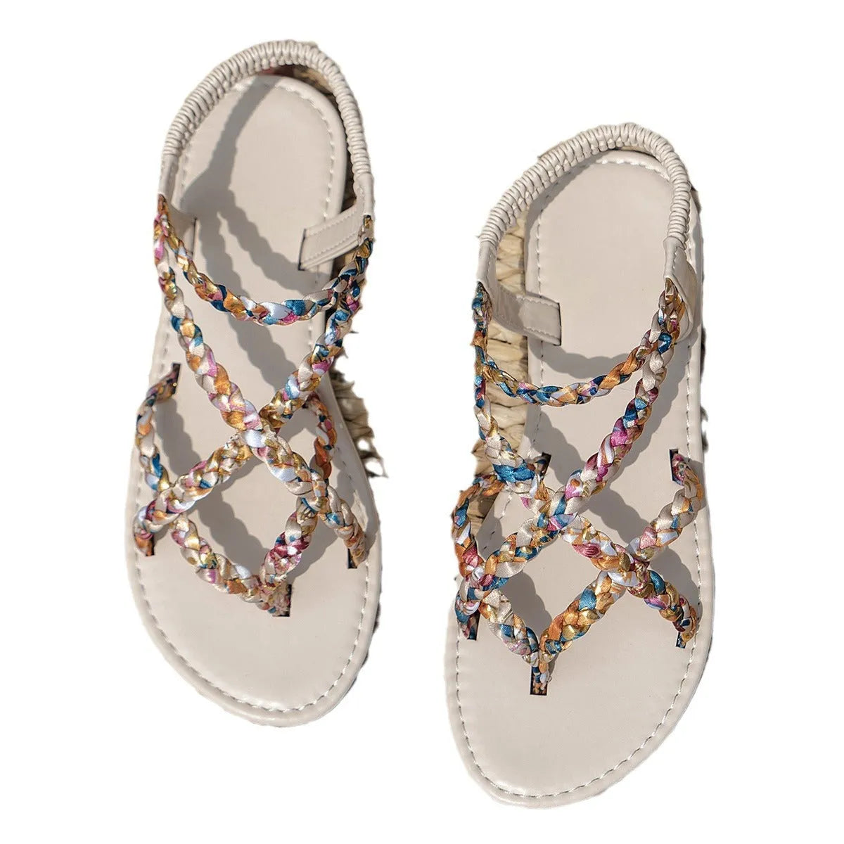 White and black flat sandals with elastic band closure and cloth upper