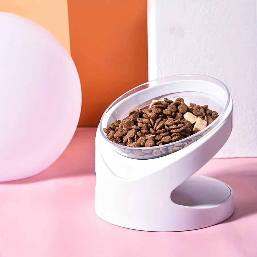 Clear elevated cat food bowl with 15-degree tilt angle on white surface