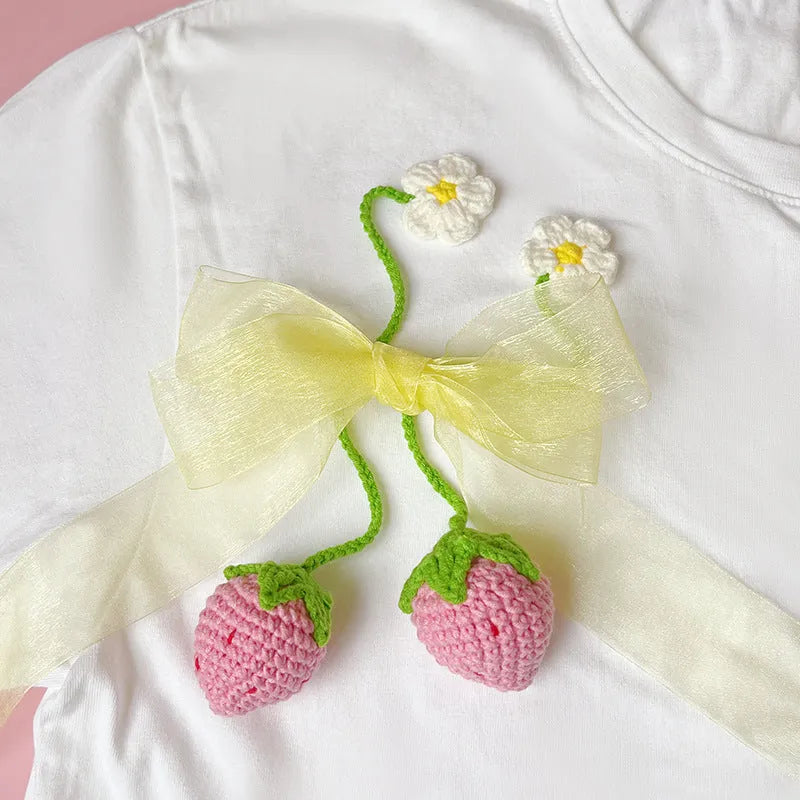 Handmade wool crochet strawberry pendant on 35cm cord, showing red or pink colour option