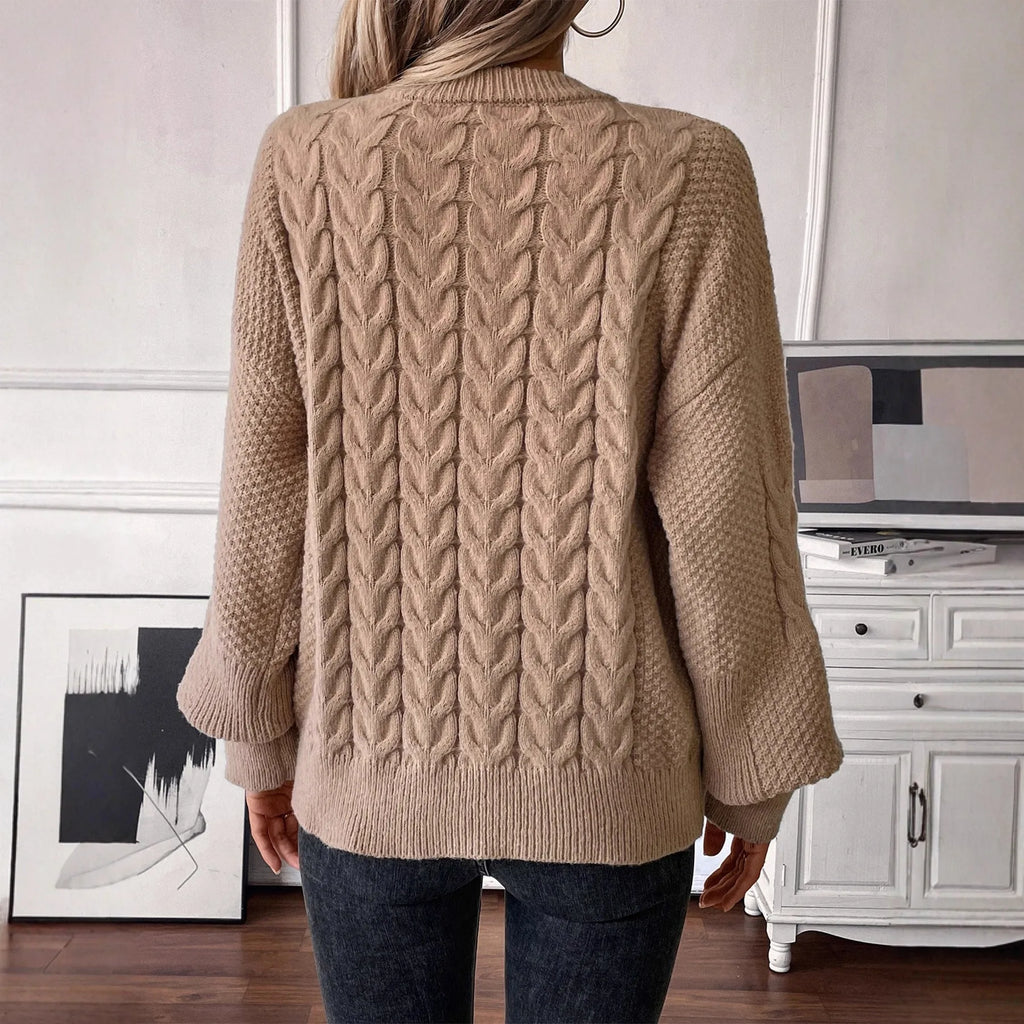 Beige women's loose round neck casual pullover sweater with textured thread detail on a hanger.