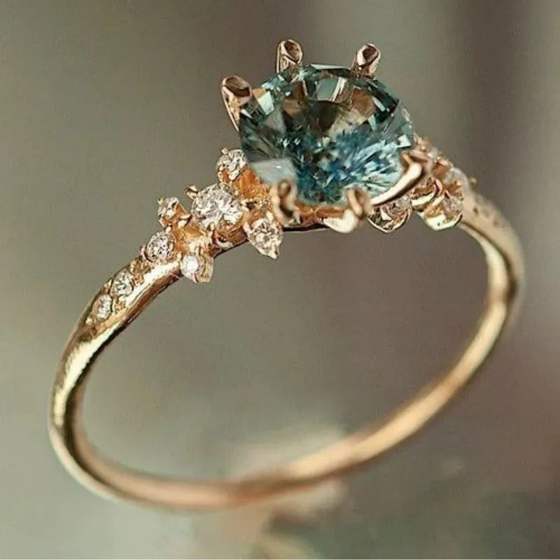Geometric gold plated ring with chamfered square pattern and zircon stones in claw setting