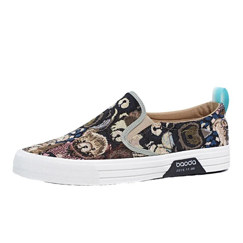 A pair of khaki-coloured canvas slip-on sneakers with a low-top profile, round toe, and vulcanised rubber sole on a plain background.