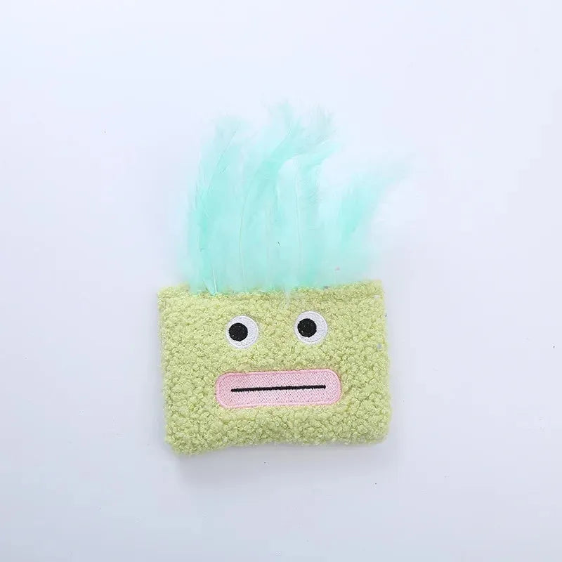 Colourful cat plush toy with a funny big mouth explosion head shape on a plain background.