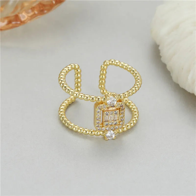 Adjustable opening copper ring with 14K gold plating and asymmetric U-shaped design