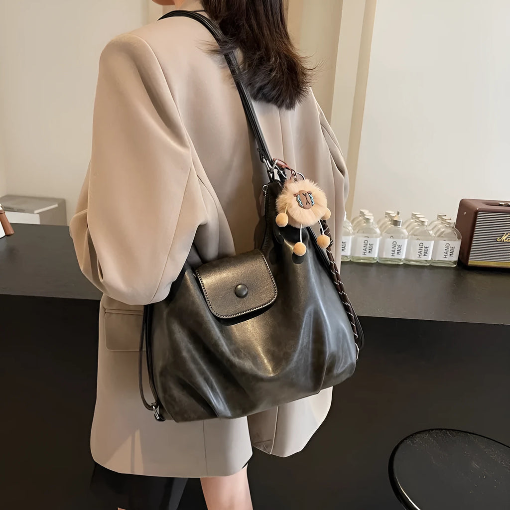 Textured PU leather women's single strap shoulder bag in a horizontal square shape, shown in black colour.