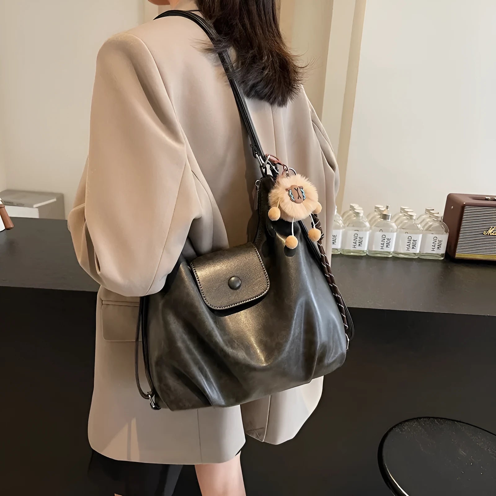 Textured PU leather women's single strap shoulder bag in a horizontal square shape, shown in black colour.