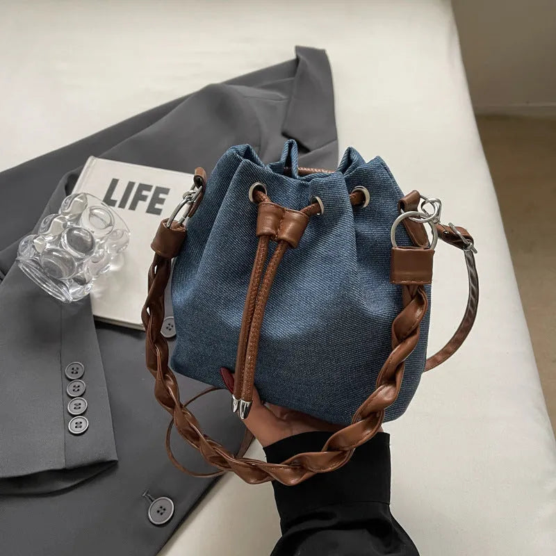 Blue one-shoulder cross body bucket messenger bag with a strap.