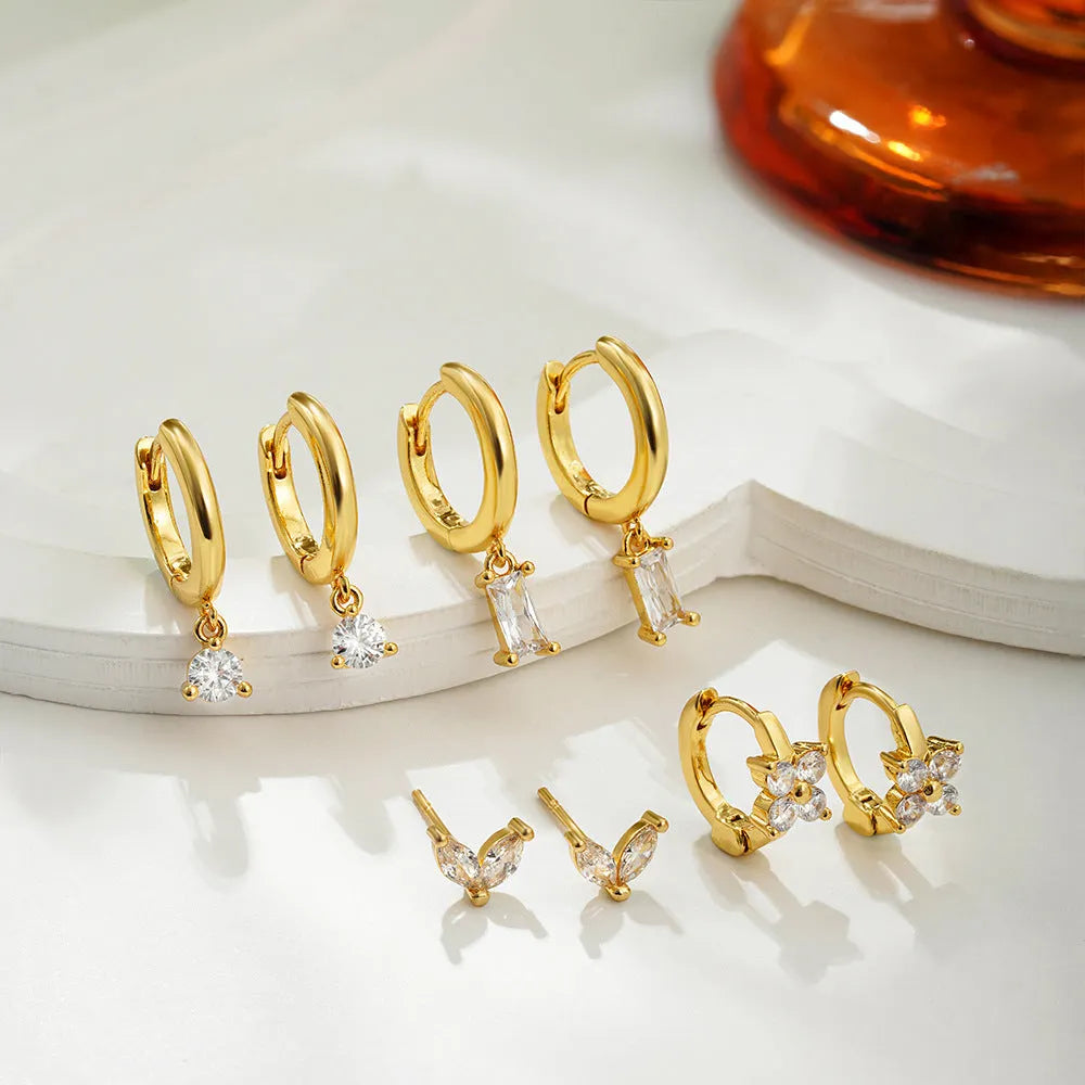 Copper geometric earrings set with electroplated gold finish showing star, ellipse, ring, and quadrilateral designs