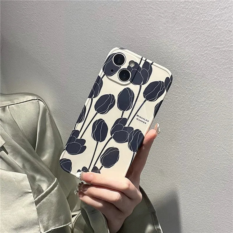 Black silicone iPhone case with a detailed tulip floral pattern on the back.