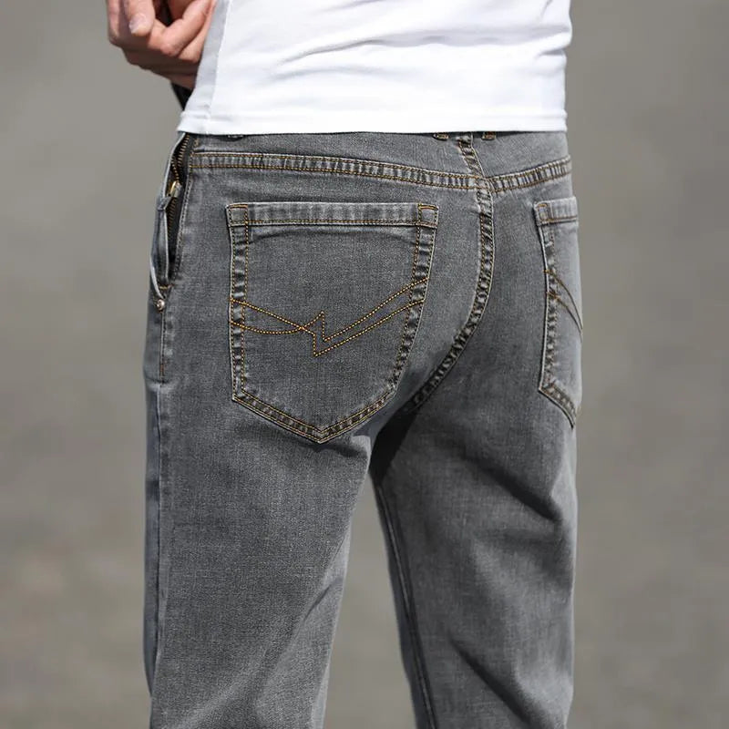 Men's straight leg jeans in smoky gray with low waist and zipper fly closure