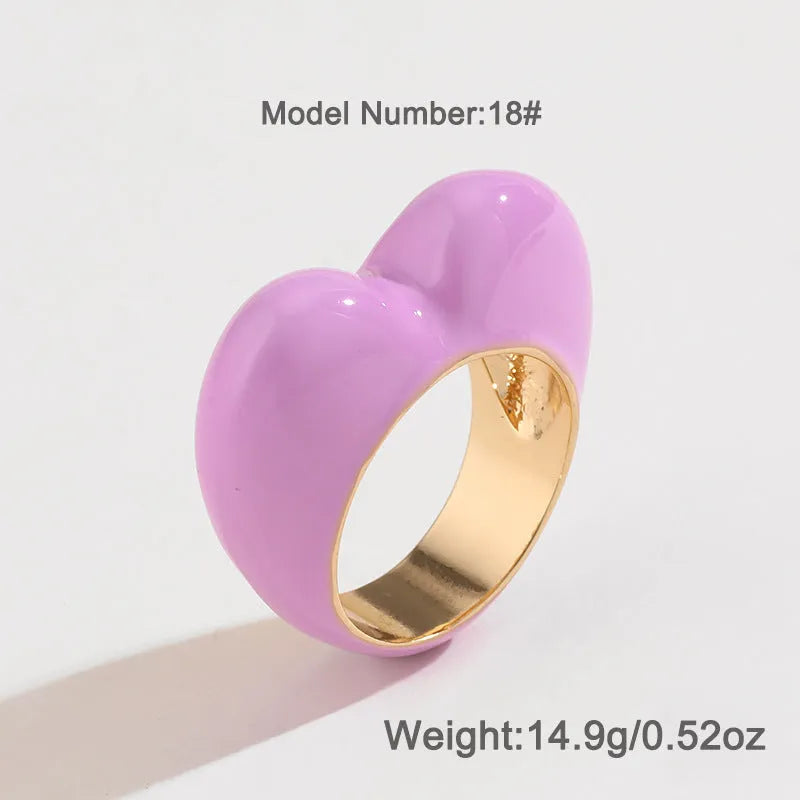 Three-dimensional heart-shaped enamel ring in black, pink, purple, or red colour, made from zinc alloy, sized 17 or 18.