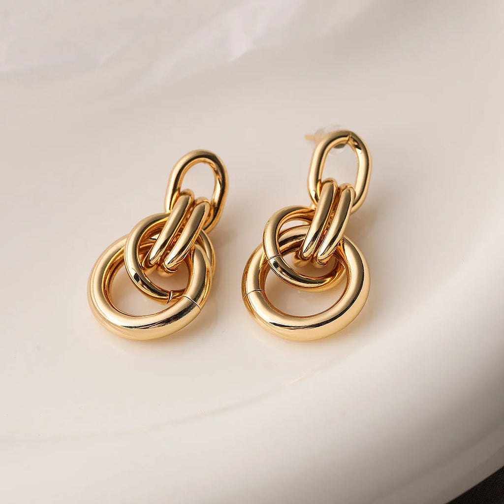 Gold geometric irregular-shaped earrings for women made from copper material