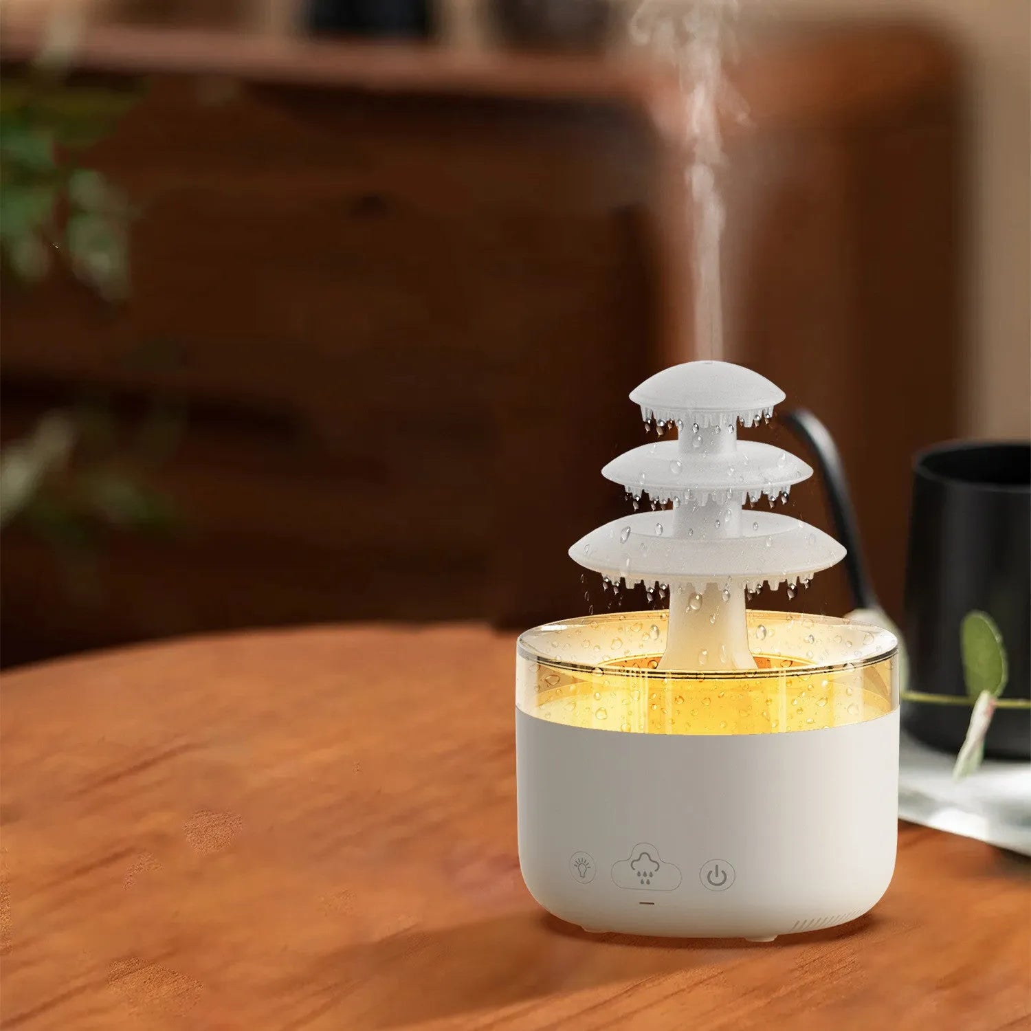 White Cloud Rain ultrasonic humidifier and essential oil diffuser with colourful LED lights on a table.