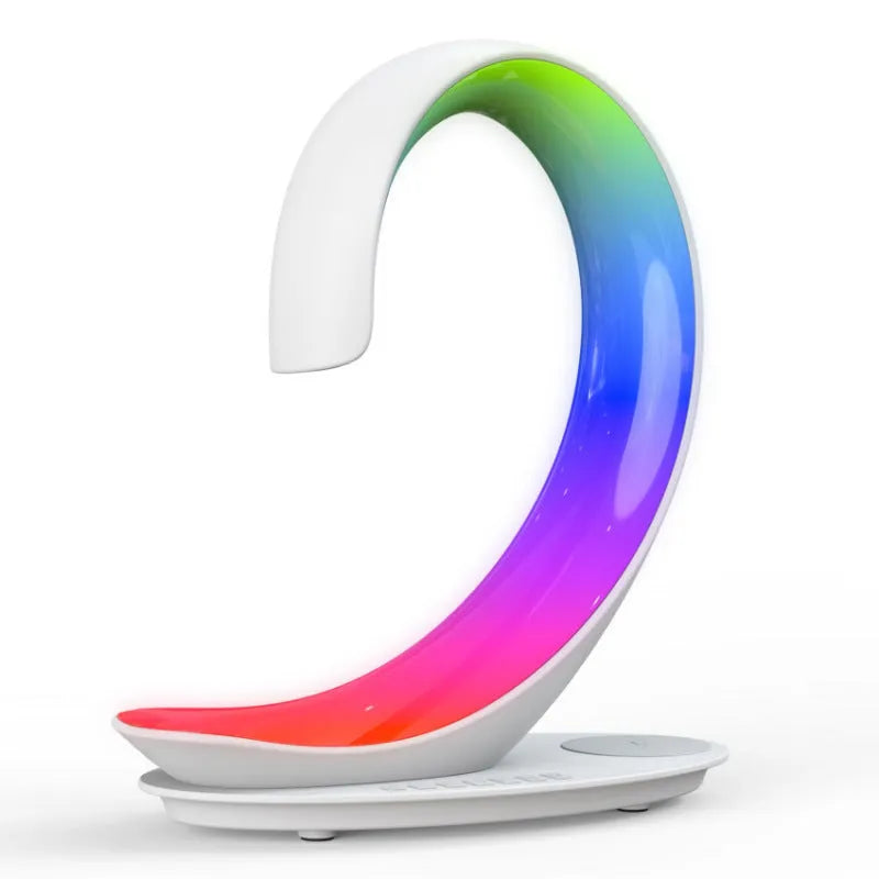 White swan shaped desktop device with colourful lighting, wireless charging pad, and Bluetooth speaker functions