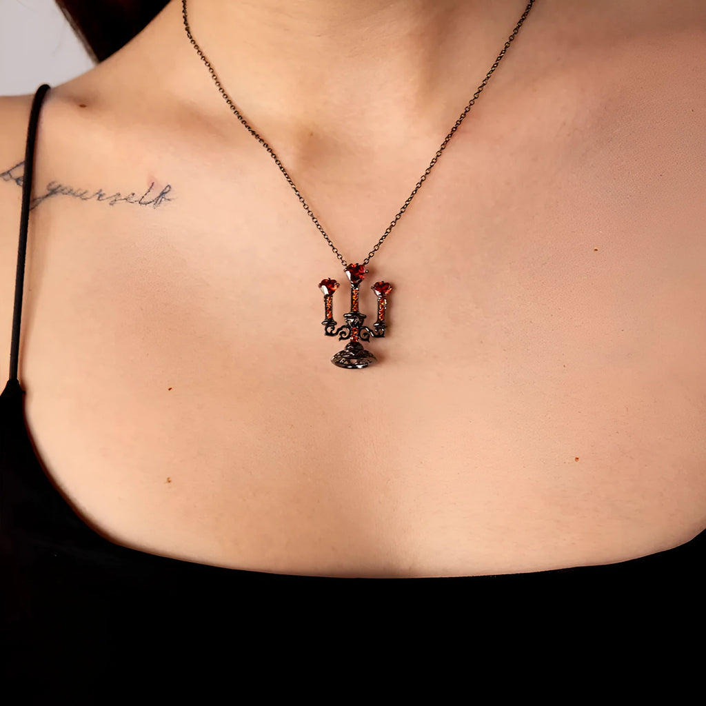 A women's gothic-style necklace with a hollow candlestick pendant on a cross chain, in a retro candlestick colour.