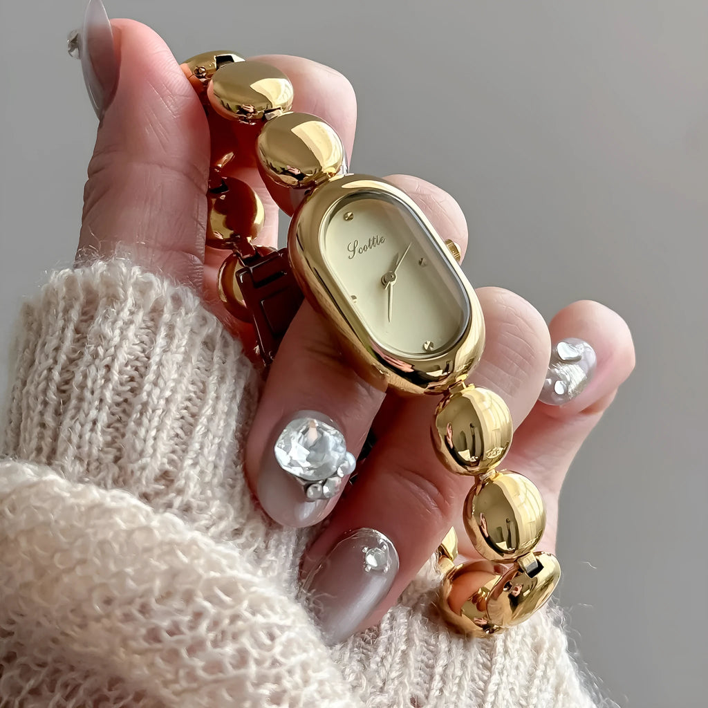 Women's oval fashion watch in black gold colour with 9mm thickness case
