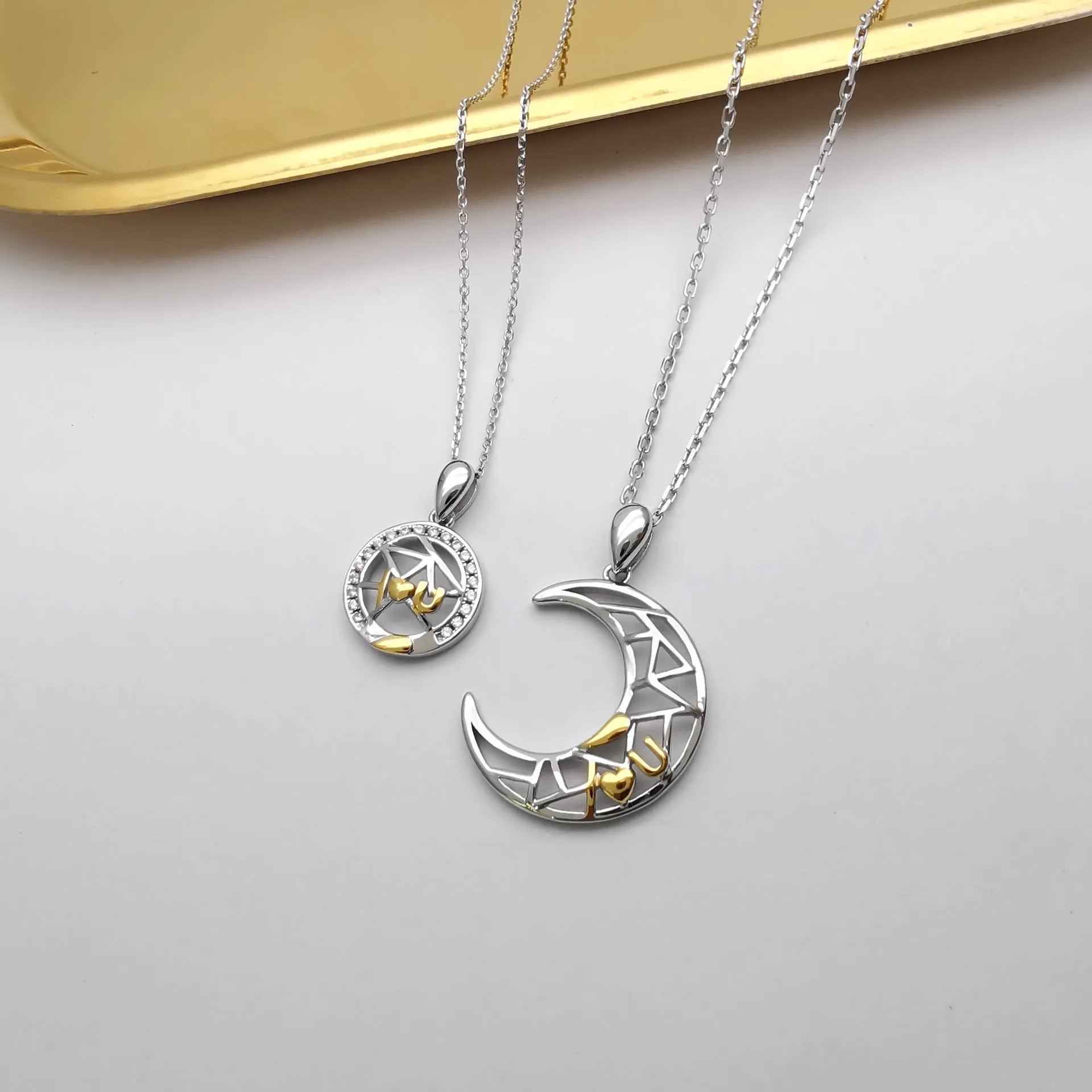 Sun Moon Tooth Couple Necklace with copper electroplated pendants showing sun and moon symbols on cross chain