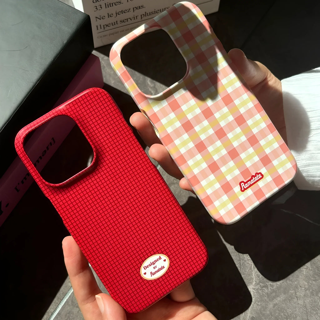 iPhone 15 Pro Max case with red and orange plaid pattern in glossy and frosted finishes