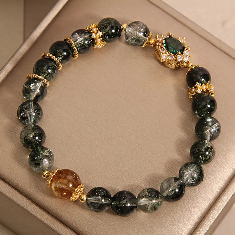 Women's gold rutilated quartz crystal bracelet with green phantom quartz beads and pearl rhinestone accents