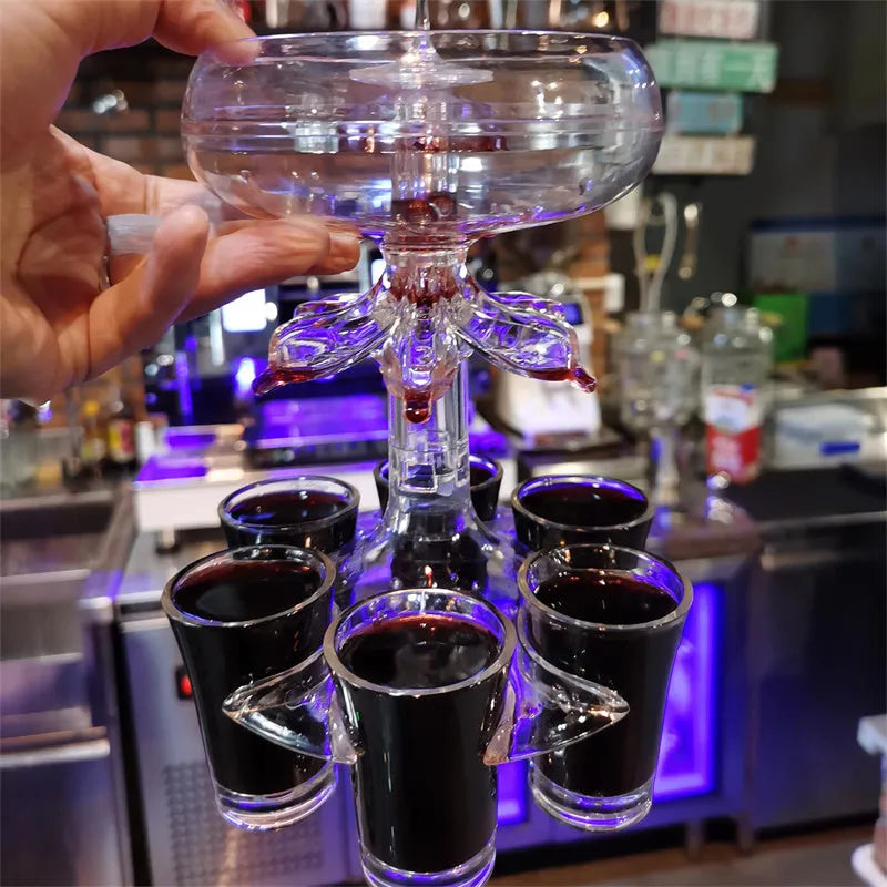 Transparent 6-shot glass dispenser rack with six shot glasses on a bar table.