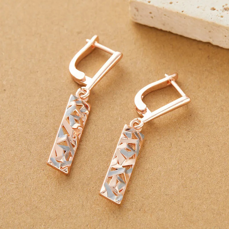 Rectangular two-tone hollow stud earrings for women with a geometric electroplated alloy design.