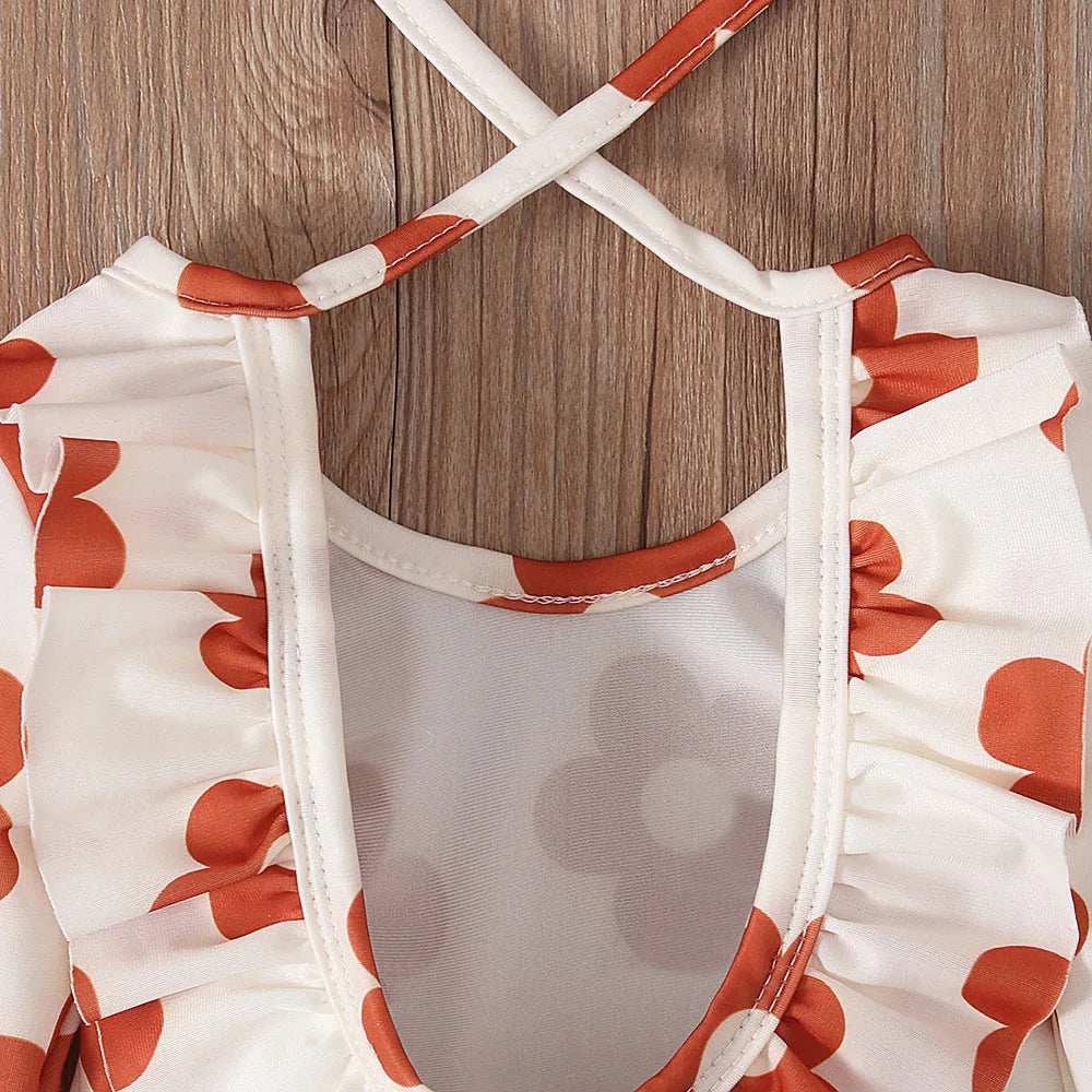 Girl's floral pattern open back swimsuit in polyester fabric showing crew neck design