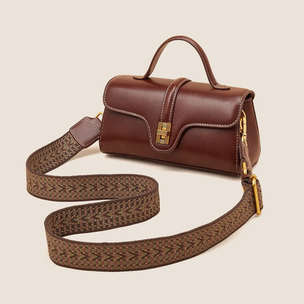 Brown Cambridge-style leather messenger bag with a front lock, shown open to reveal internal zipper pockets.
