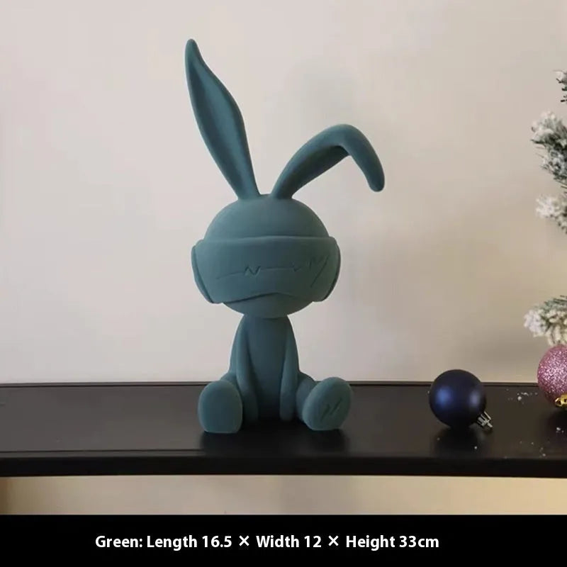 Green suede blindfold rabbit resin ornament on a wooden table, 15cm tall
