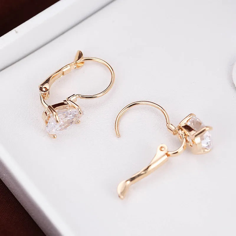 Drop-shaped copper earrings with platinum inlaid gem, gold or platinum plating, approximately 2.5 cm long