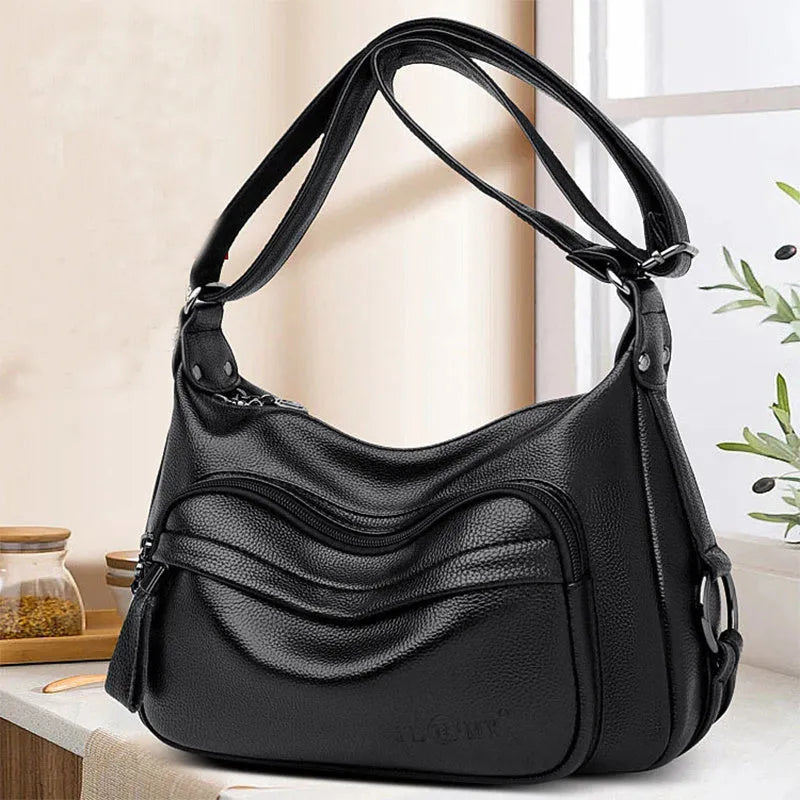 Large blue PU leather women's crossbody bag with zipper closure showing internal organiser pockets