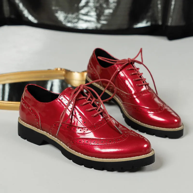Women's black PU oxford loafers with a wedge heel and sequin details, showing lace-up front.