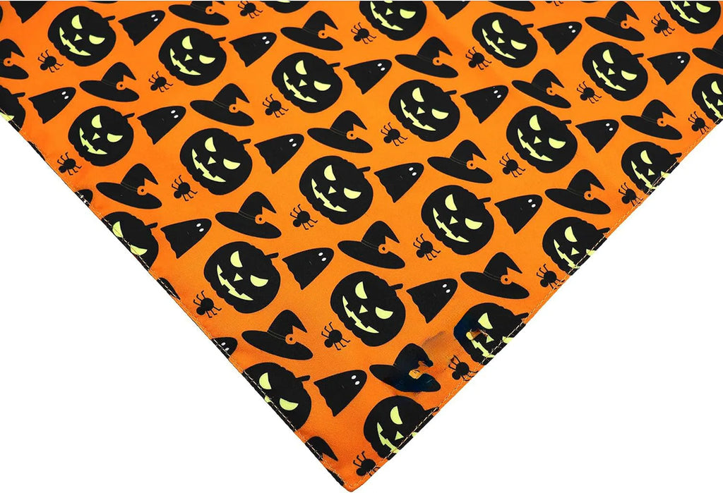 Black and orange reversible Halloween dog bandana with pumpkin and spider web patterns, shown on a dog's neck.