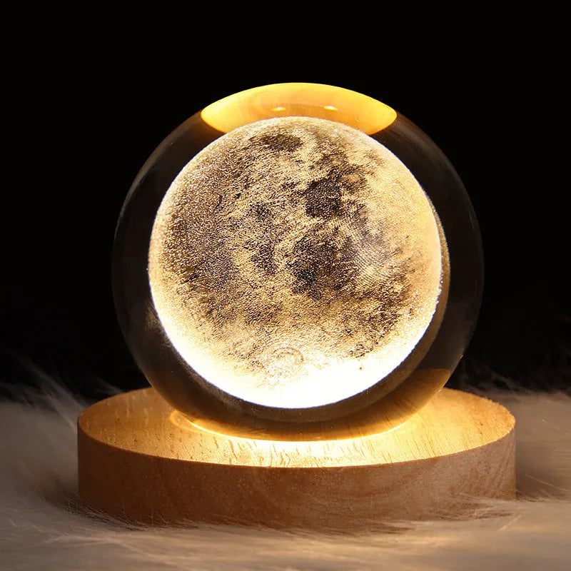3D crystal ball night light projecting starry sky and planets from its 6cm sphere on a solid wood base.