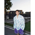 Men's pink floral long-sleeve shirt with embossed texture, loose fit, on hanger