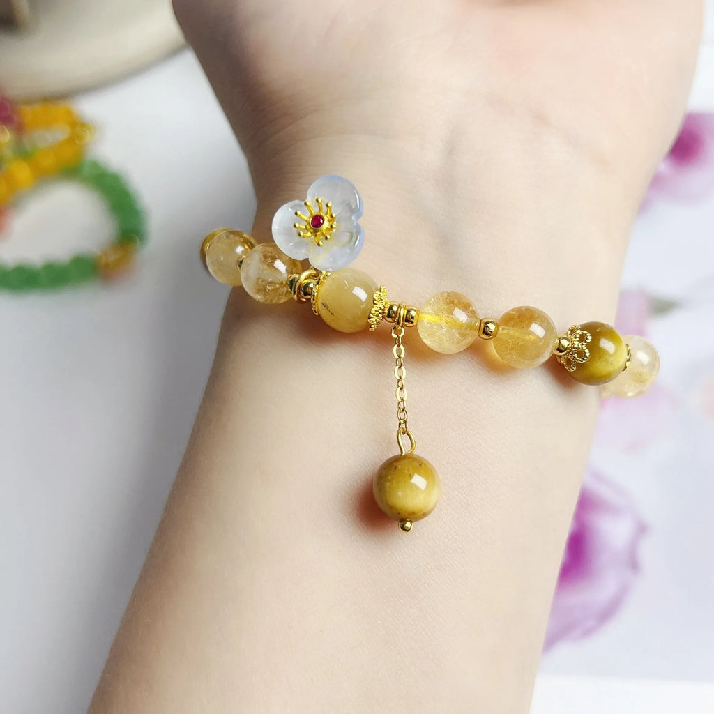 Handcrafted citrine crystal bracelet for women with a flower and tassel design.