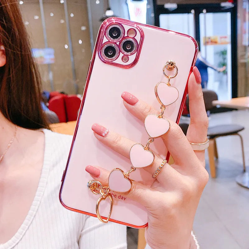 Solid colour silicone mobile phone case with an attached wrist strap for Samsung Galaxy smartphones.