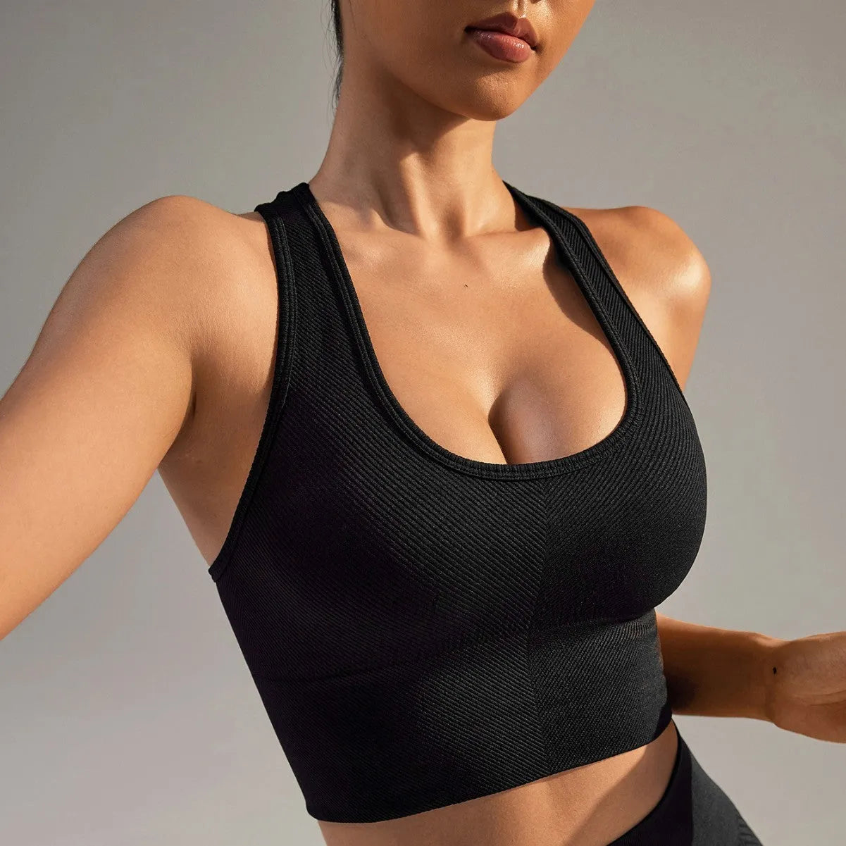 Black women's cross back sports bra with fixed double straps and molded cups.