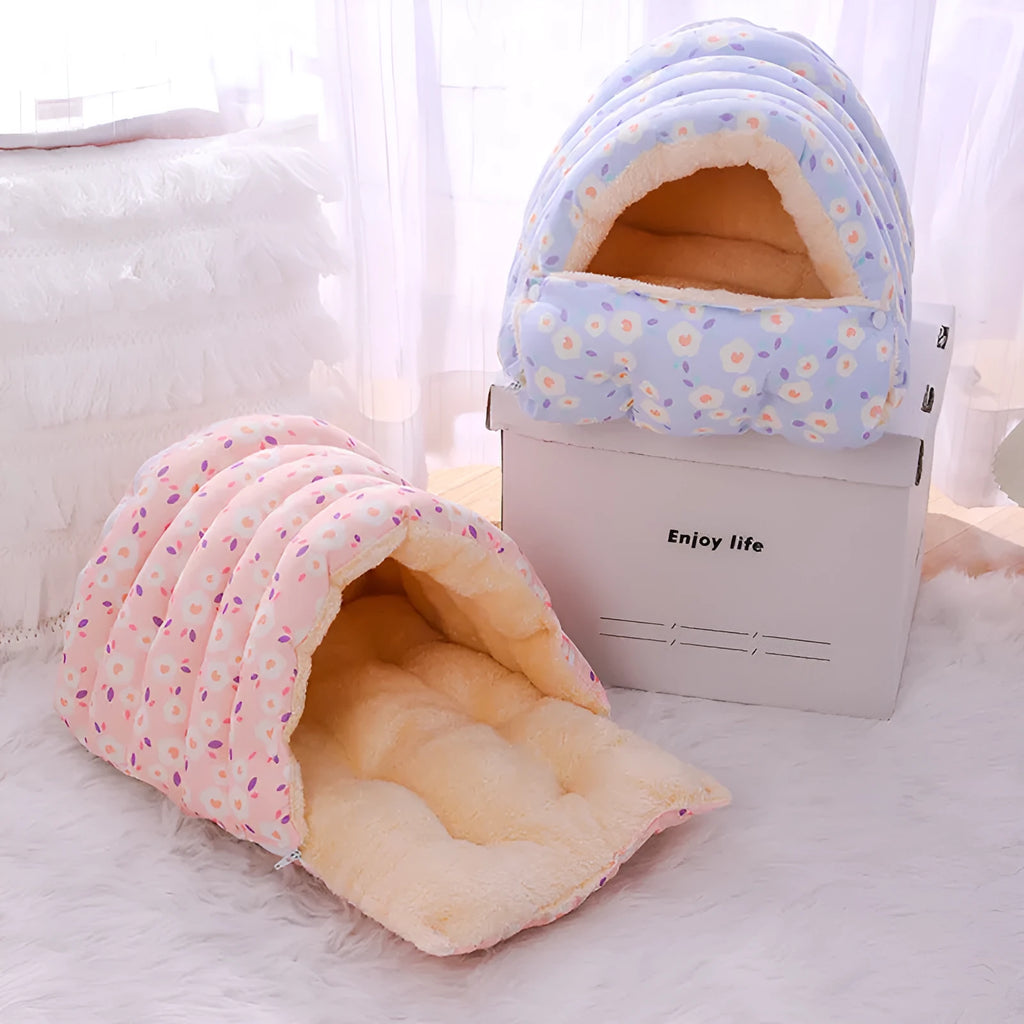 Closed cloth cat bed with removable cushion in a pink small flower pattern.