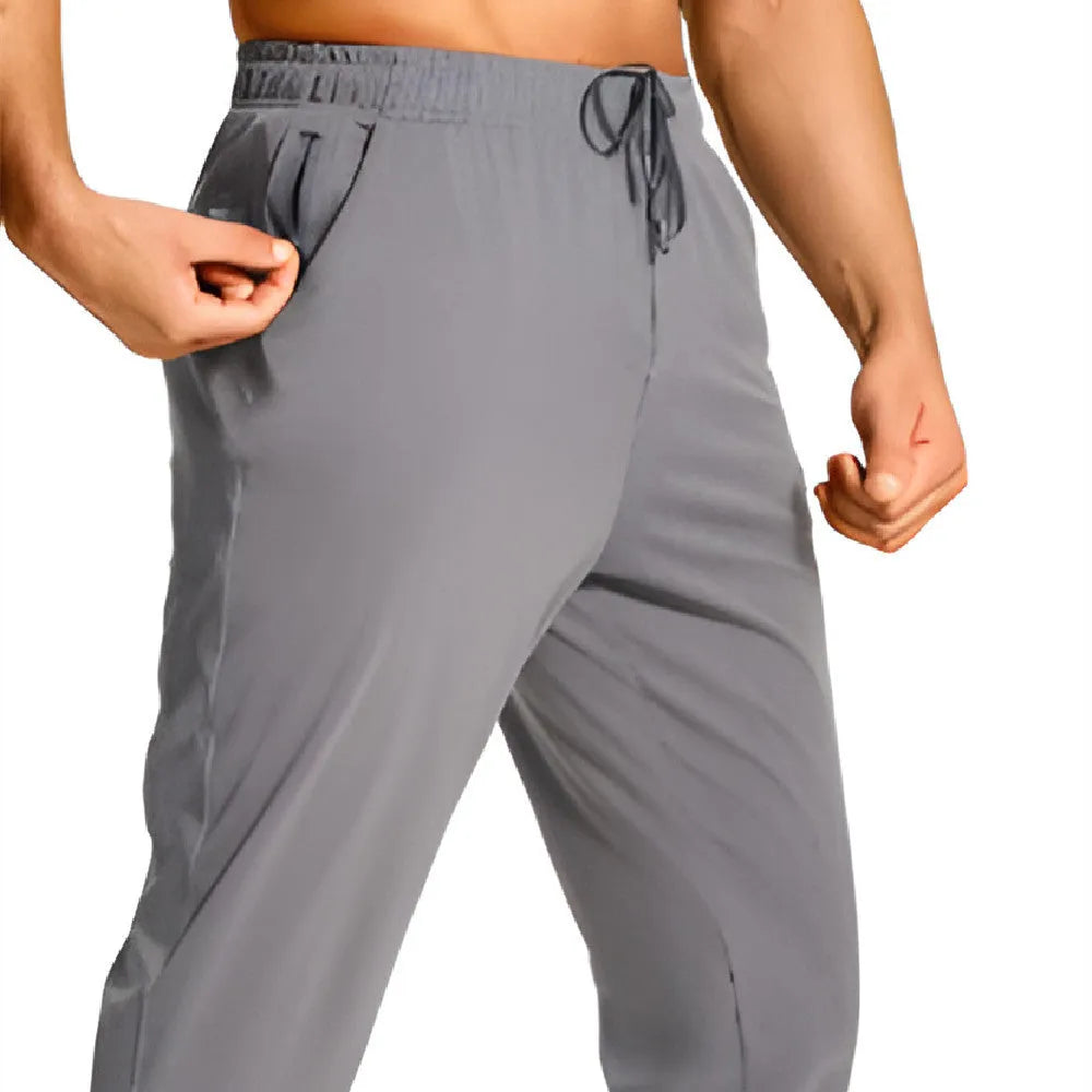 Men's loose casual trousers in solid colour, made from 100% polyester fabric, available in multiple sizes and shades for leisure wear
