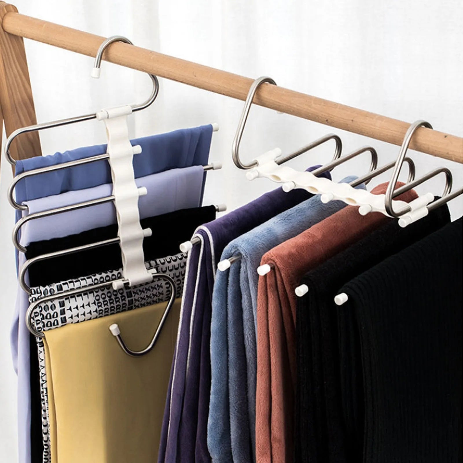 Black stainless steel 5-in-1 multi-functional trousers hanger with five booms on a clothes rack