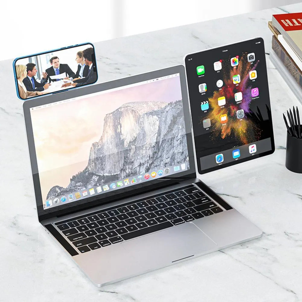 Black aluminium laptop phone holder with magnetic bracket mounted on a monitor, showing a smartphone attached for dual-screen use