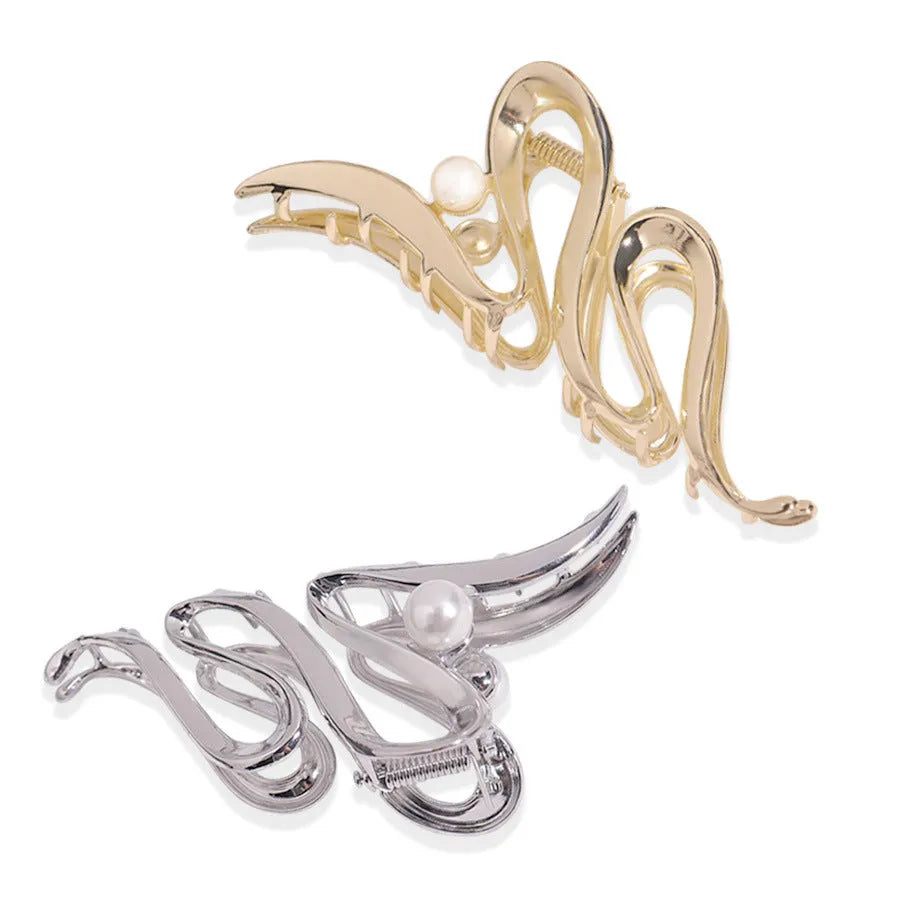 Assortment of silver metal hair claw barrettes in various shapes including waves, bows, and crosses.