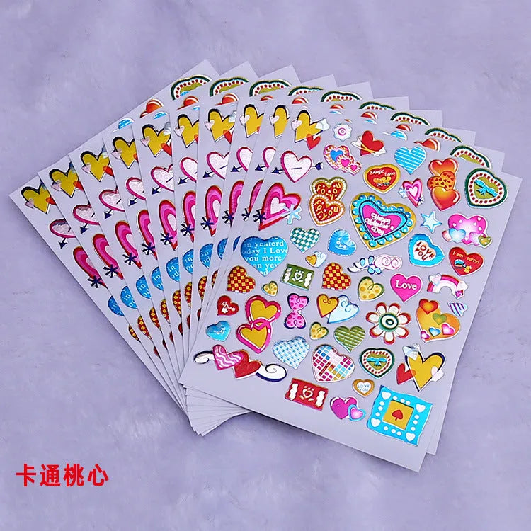 100-piece pack of gold-detailed cartoon heart waterproof reward stickers laid out.