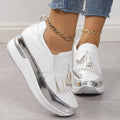 Women's black casual platform shoes with a tassel and muffin wedge heel on a white background.